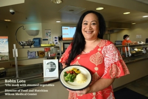 Wilcox Medical Center Director with a plate of Ulu Mash and Steamed Veggies