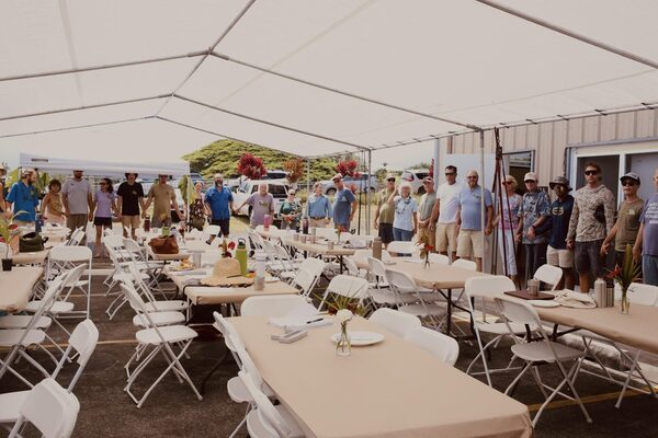 Farmer-members gathered under a tent at the 9th Annual Member Meeting at the ʻAlae Postharvest Facility in Hilo