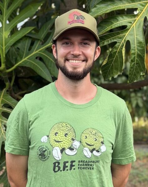 Ryan Weiskopf, Producer Support Lead, standing in front of ʻulu leaves