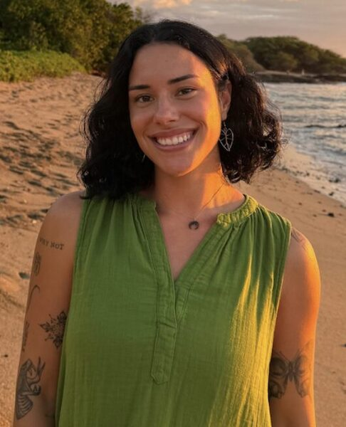 Venus Rodin, Community Outreach Assistant, at the beach at sunset